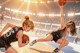 A couple of girls playing basketball on a court.