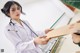 A woman in a white lab coat holding a clipboard and a stethoscope.